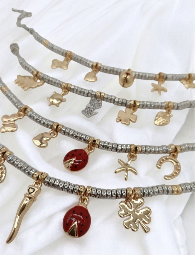 Bracciali granelli argento e oro giallo con charms